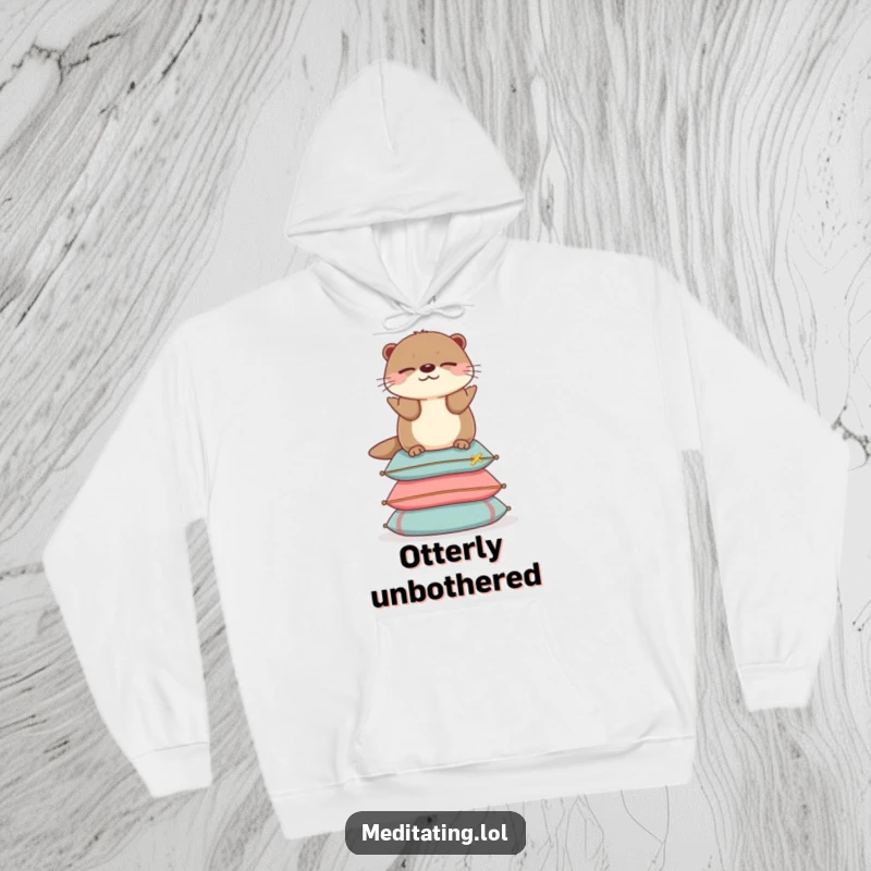 Funny otter hoodie showing a cheerful otter balancing serenely on cushions, offering cozy comfort and calm.